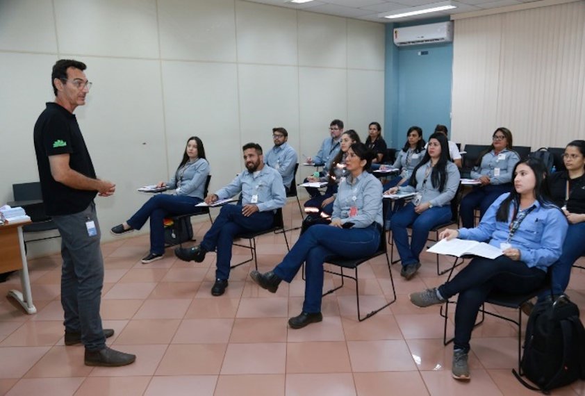a person standing in front of a group of people sitting in chairs