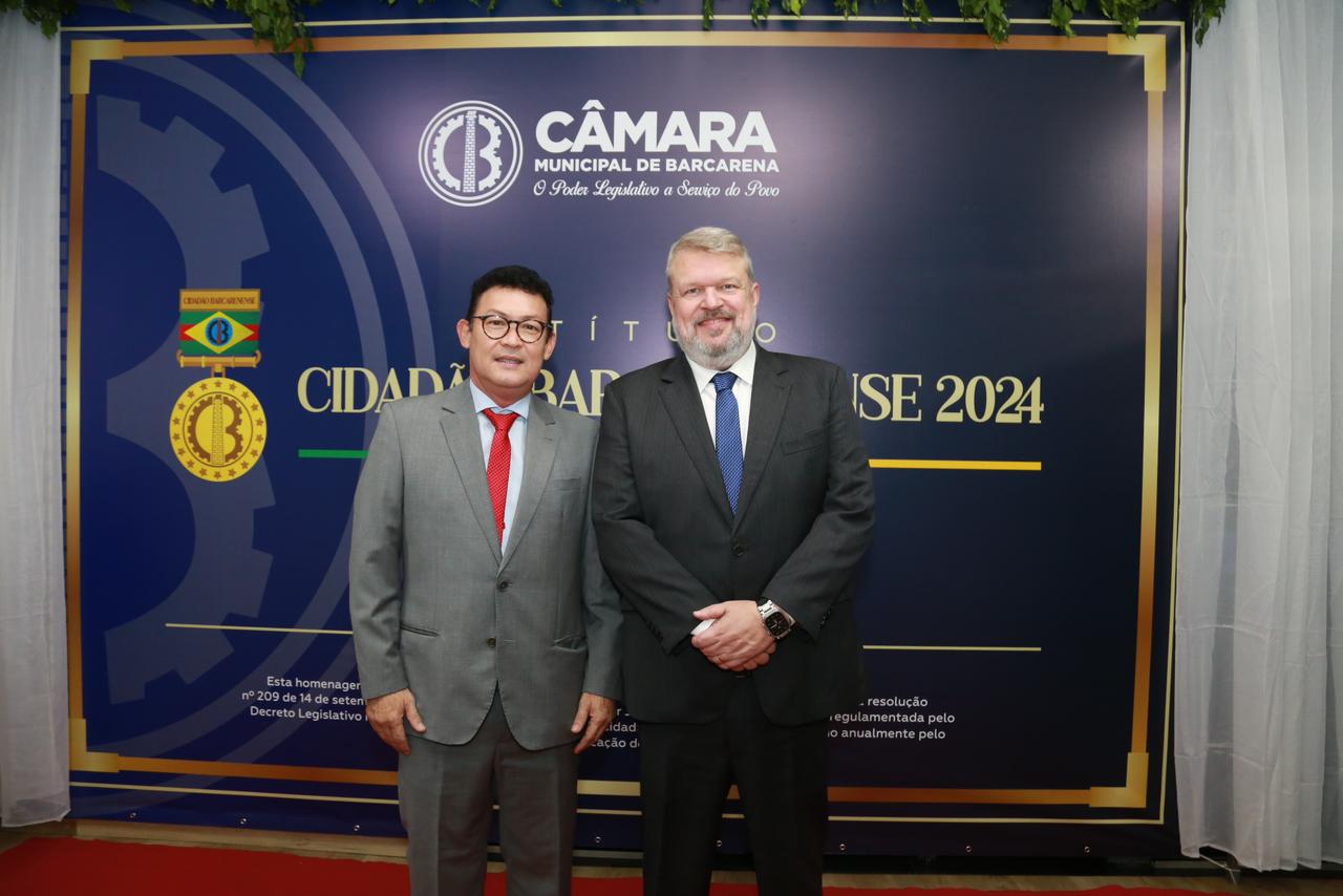 a couple of men standing in front of a sign