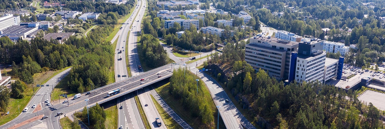 a highway with a bridge and buildings