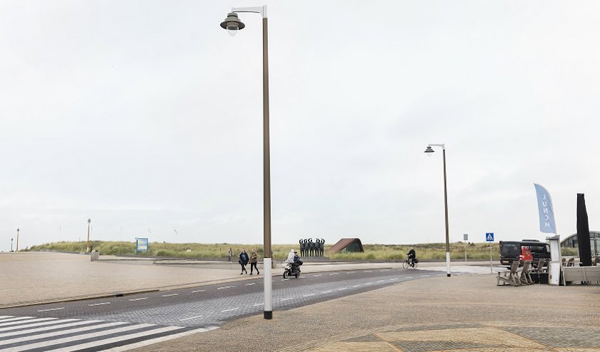 a road with a street light and a person riding a bicycle