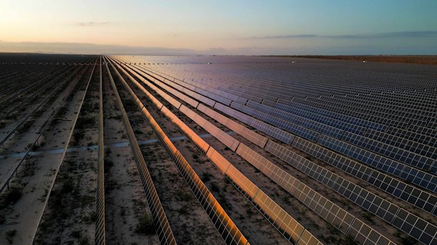 a road with rows of solar panels