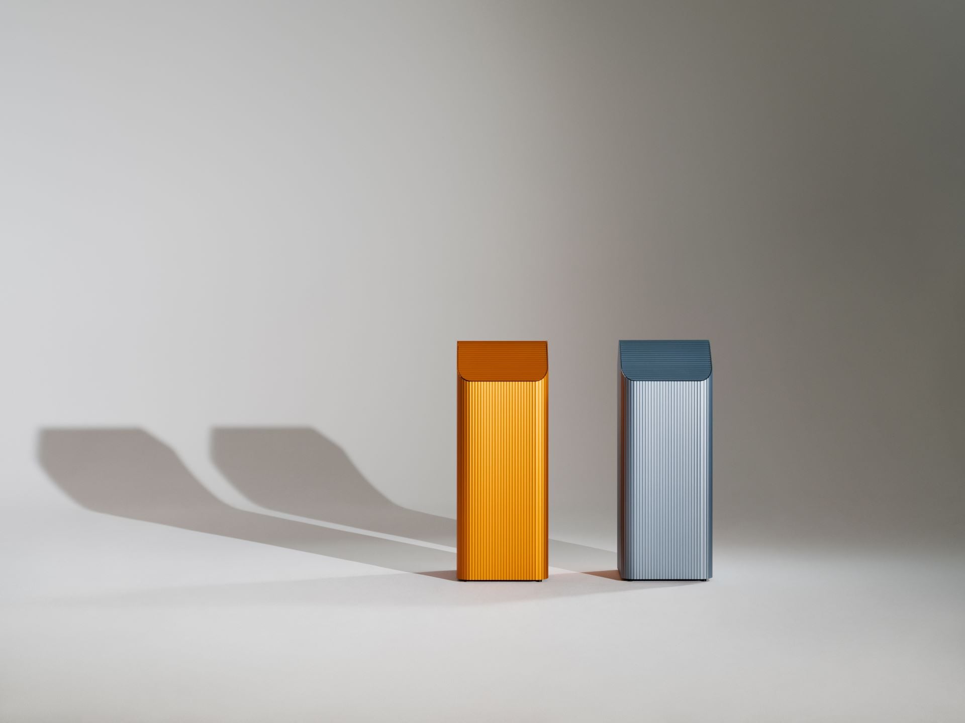 Two metal containers on a white surface