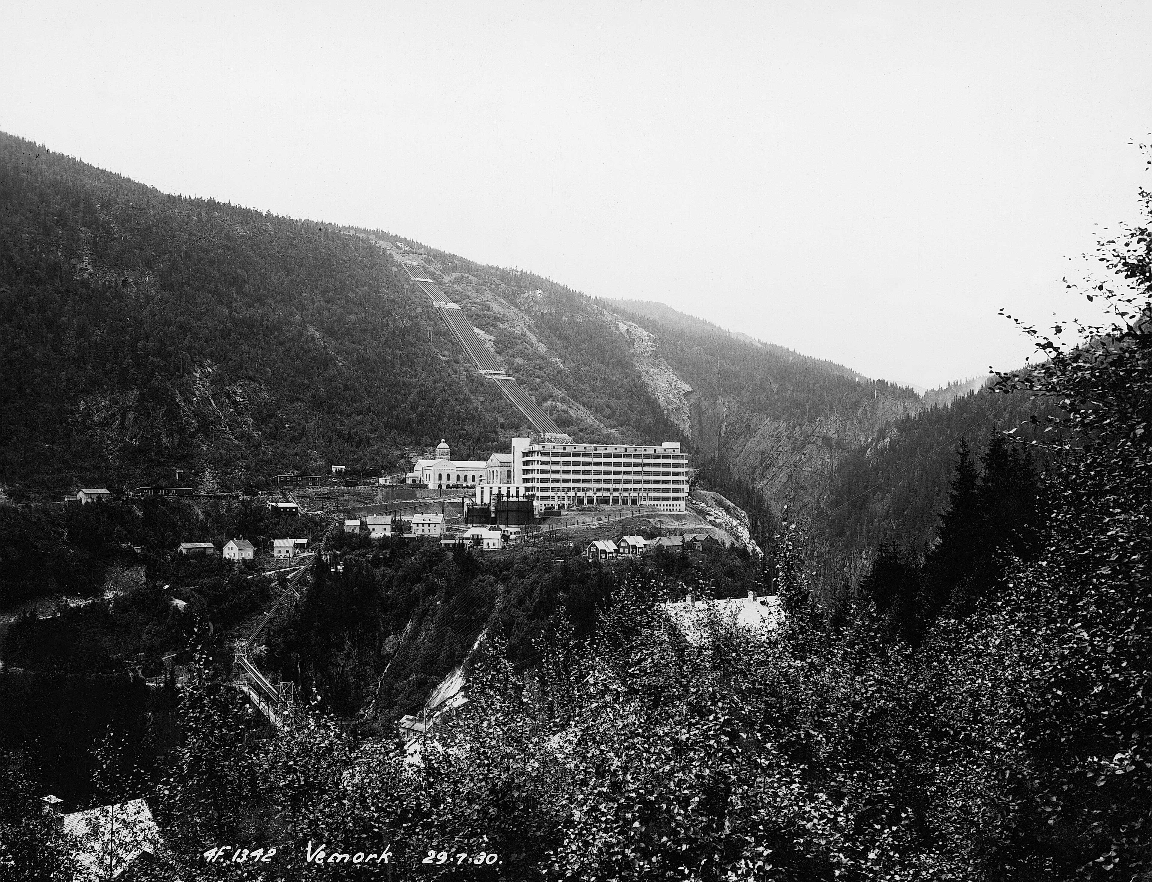 a black and white photo of a town in the mountains