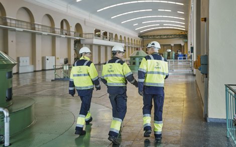 workers inside a large power station hall