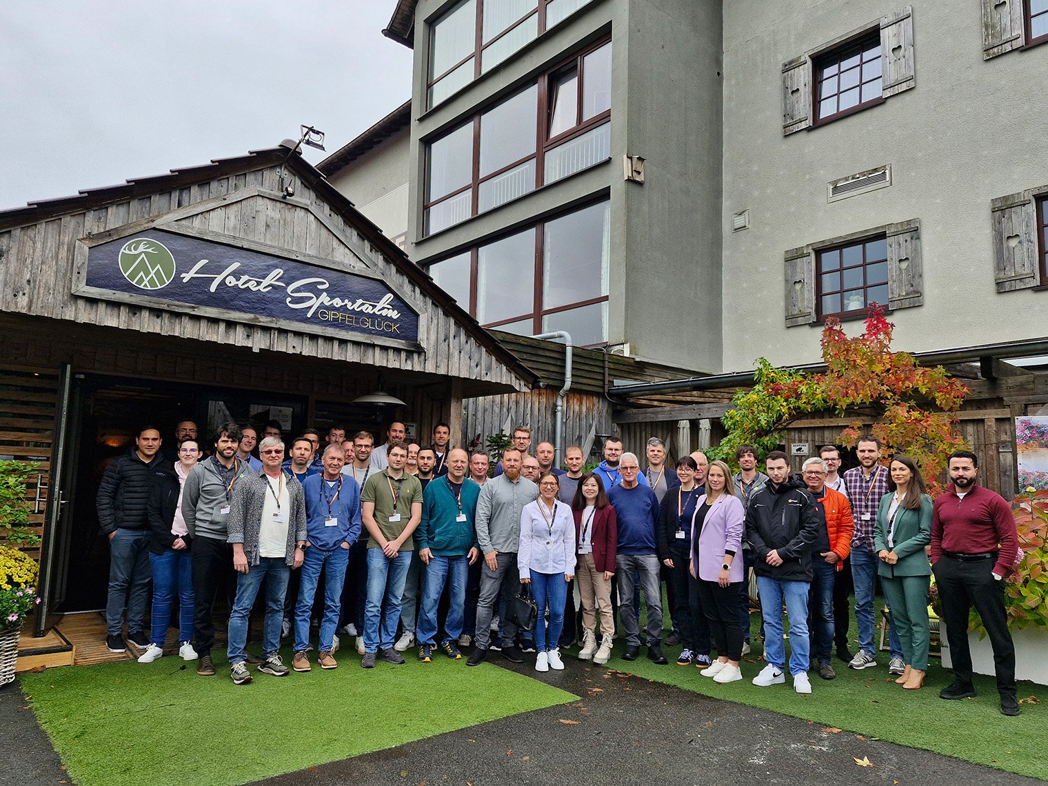 a group of people posing for a photo outside of a building