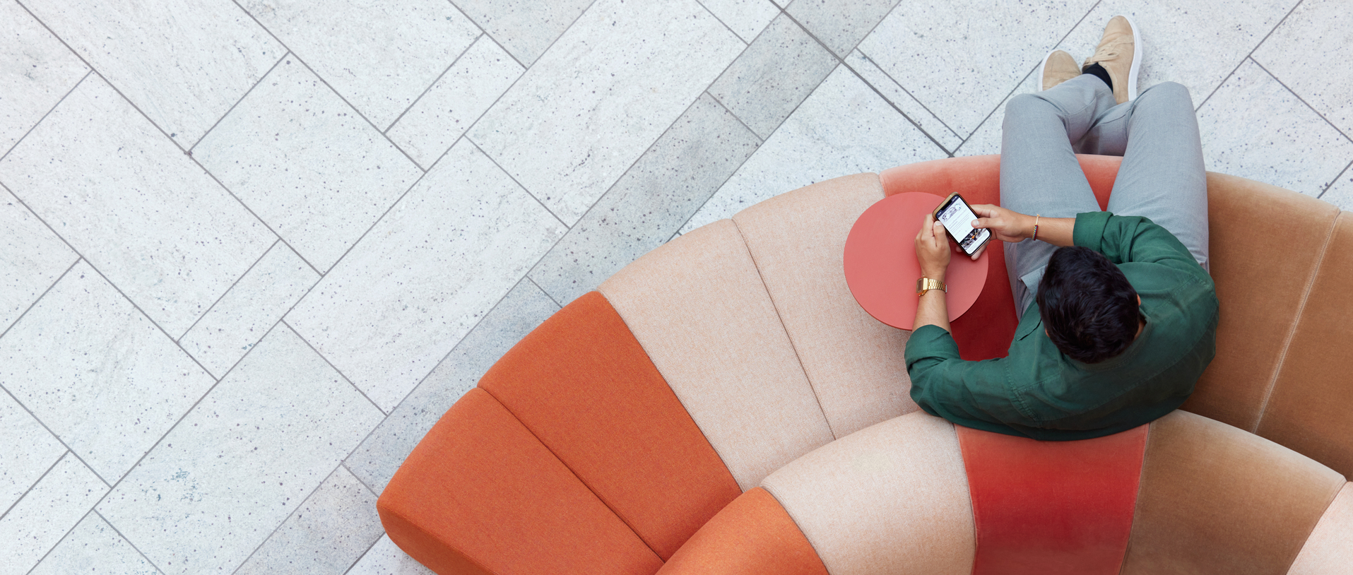 a person sitting on a couch looking at the phone