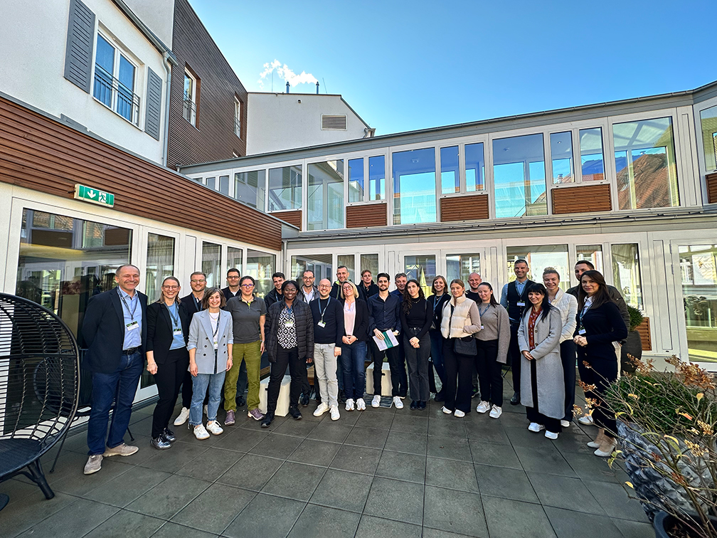 a group of people posing for a photo outside a building