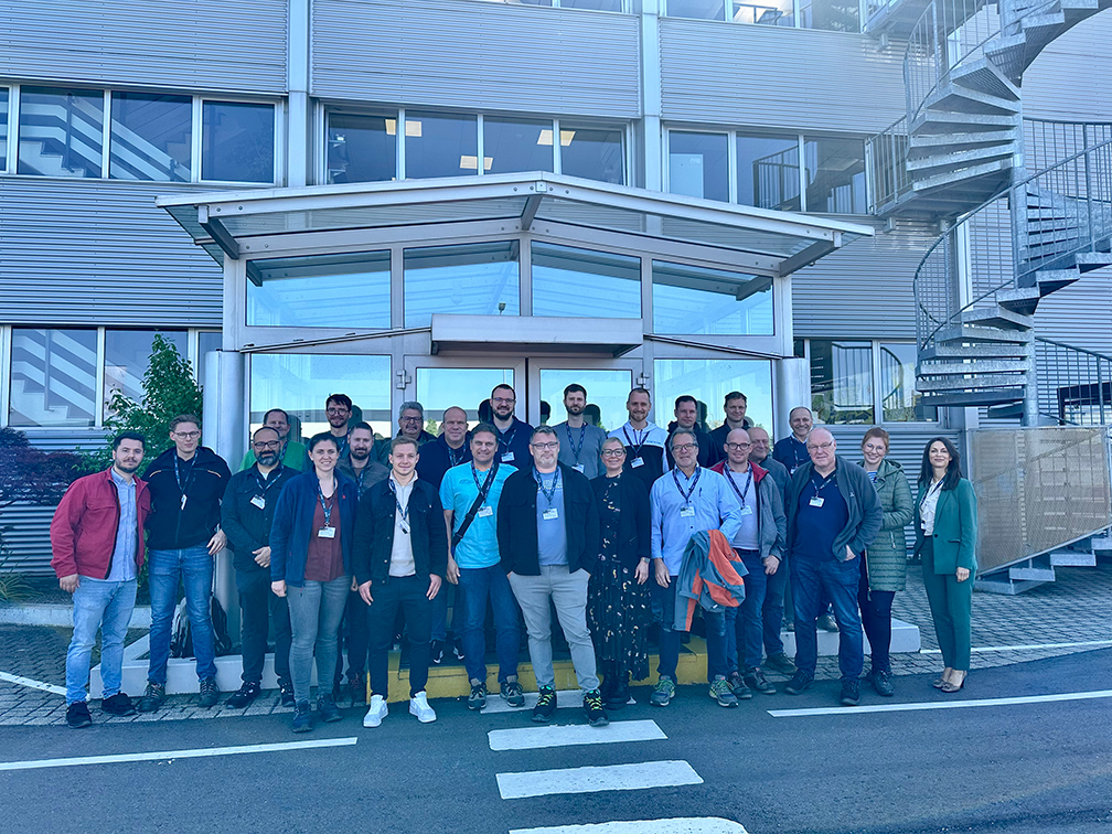 a group of people posing for a photo in front of a building