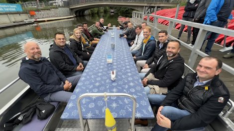 a group of people sitting at a table on a boat