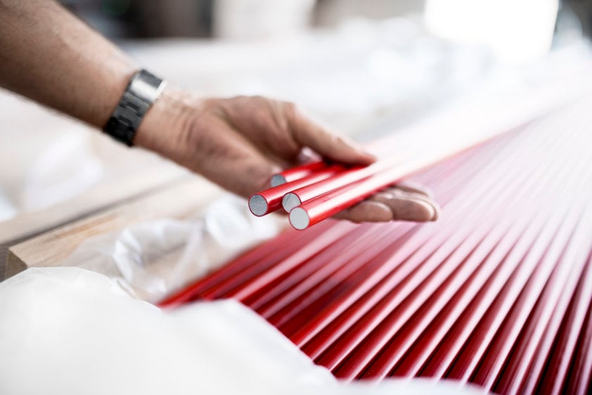 A person holding aluminium busbars