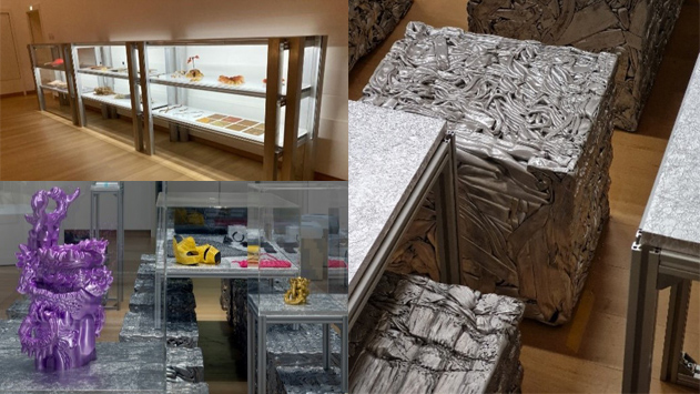 a room with a bed and a table with a chair and a shelf with objects on it