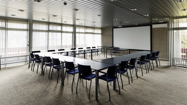 large conference room with many chairs and a large projector screen