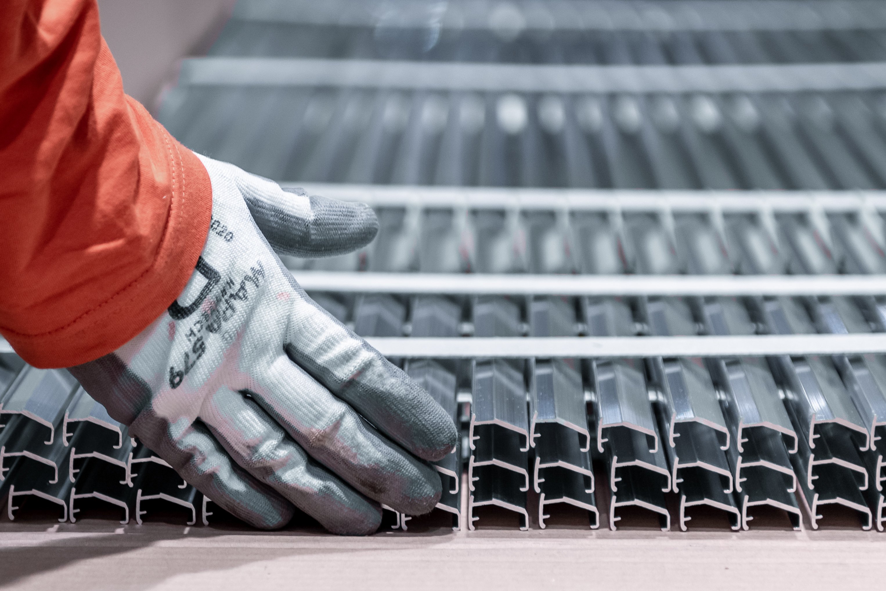 a hand in a glove touching metal bars