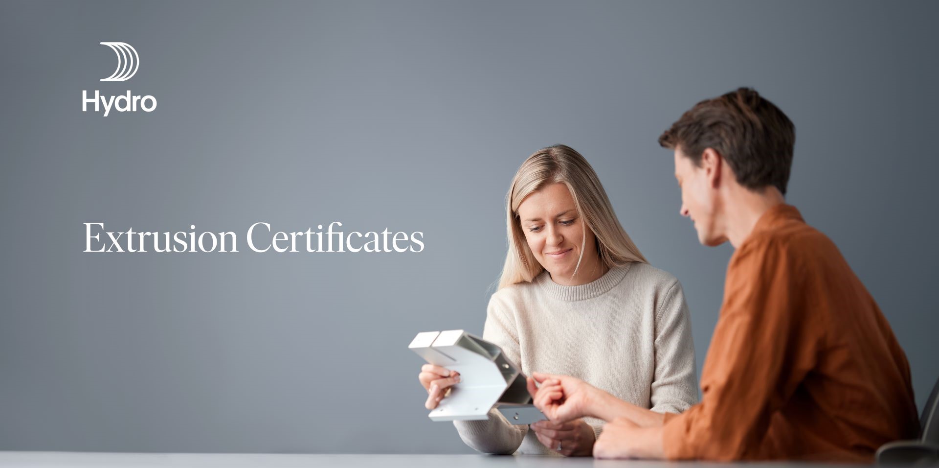 a man and a woman looking at a tablet