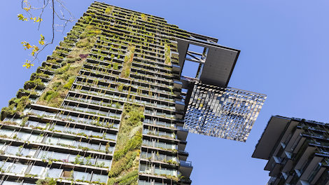 Low angle view of apartment building with vertical garden and heliostat