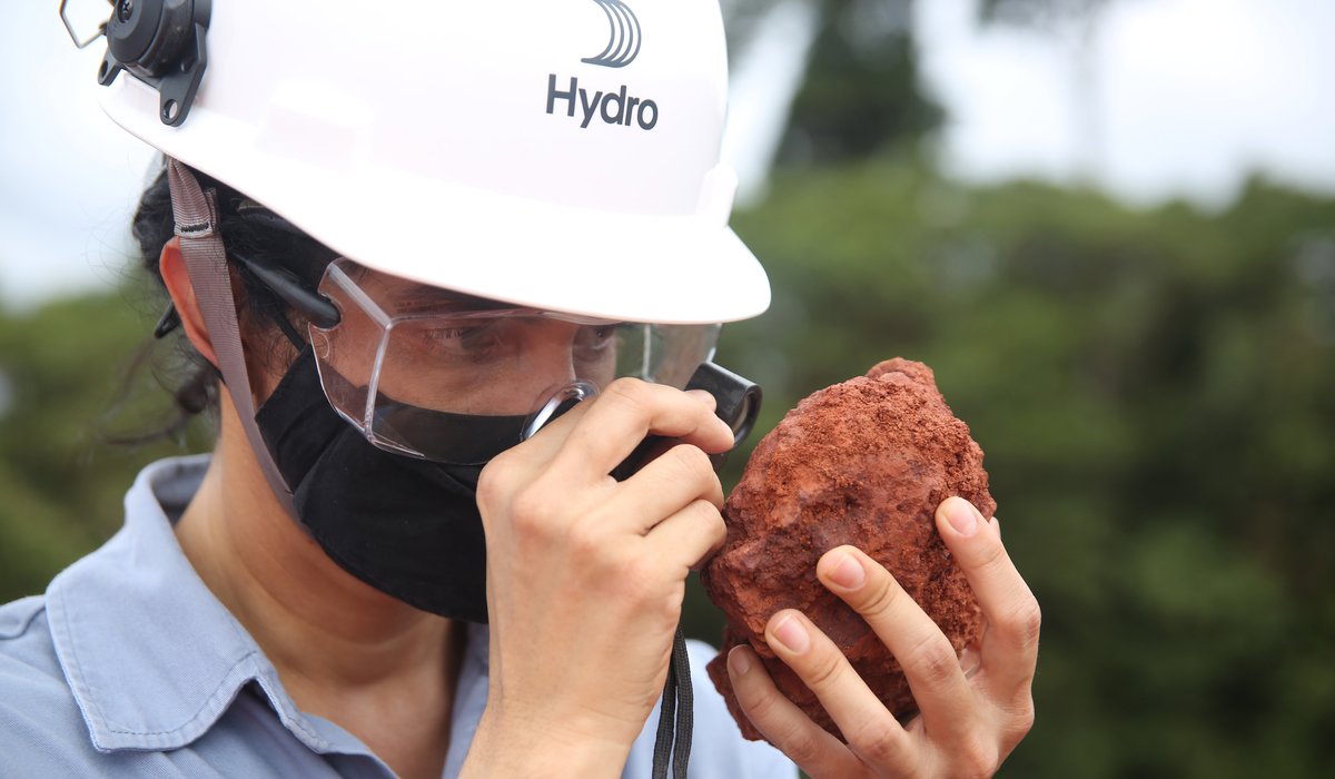 Hydro employee inspecting bauxite