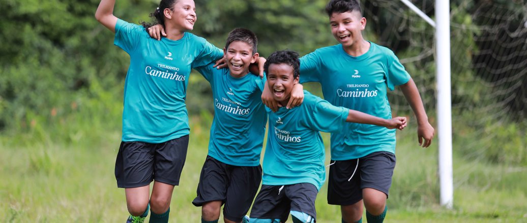Children in sports attire on a soccer field