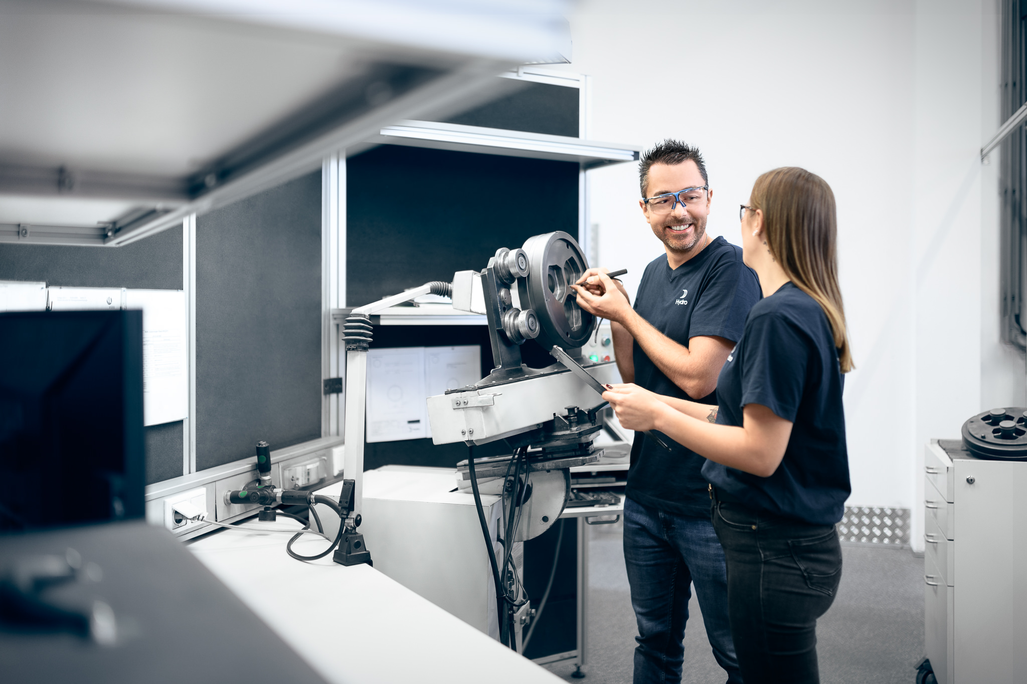 a man and woman standing next to a machine