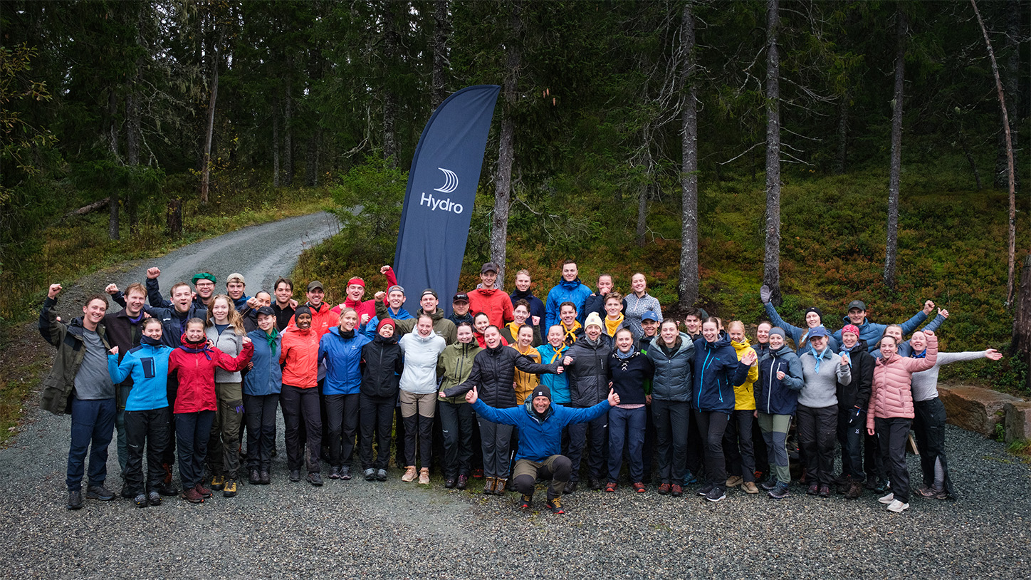 a group of people posing for a photo in the woods