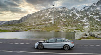 Mercedes-Benz in the mountains with windmill in the background