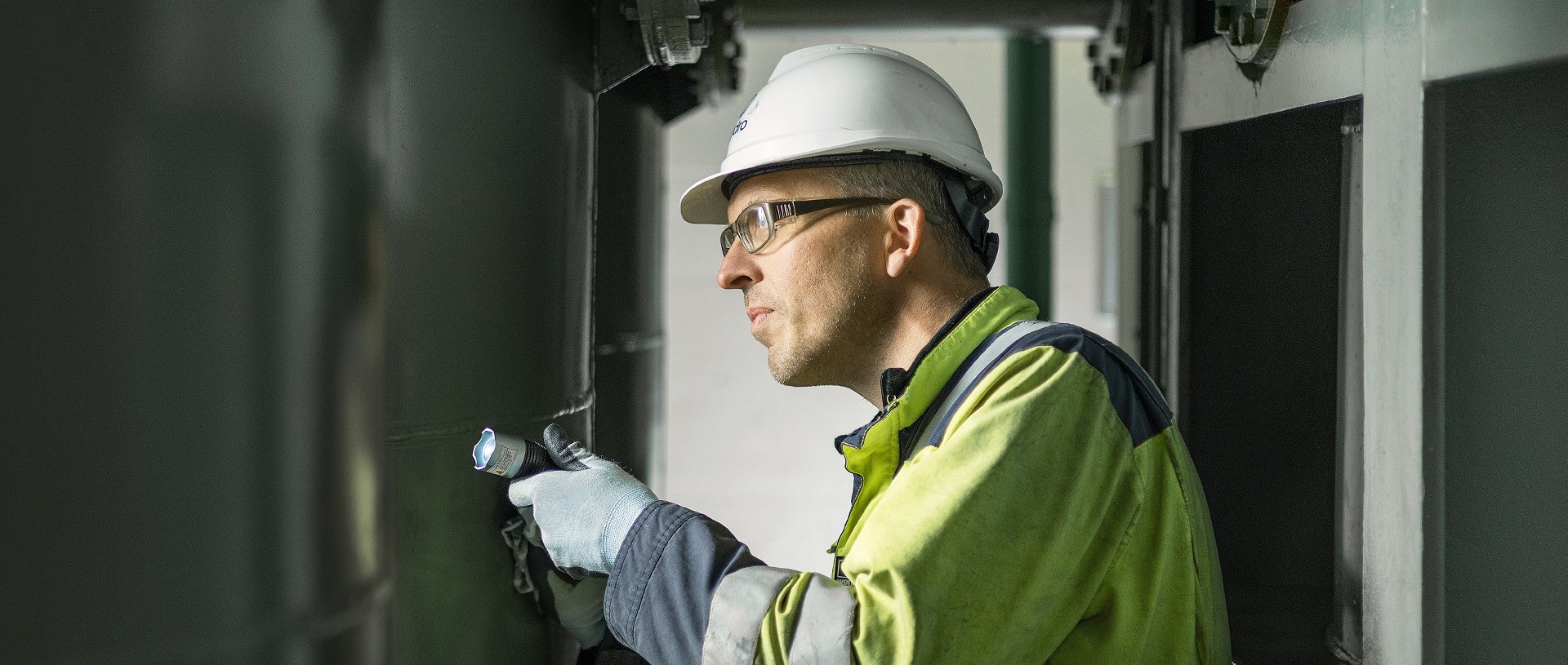 a man wearing a hard hat and safety goggles