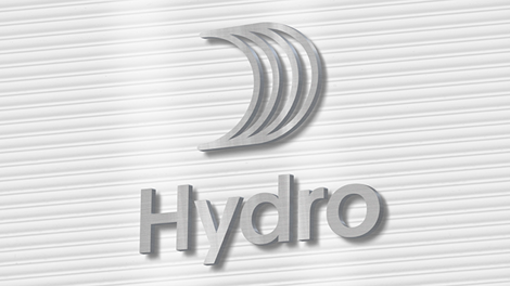 Hydro logo with sail made from metal, on a striped wall