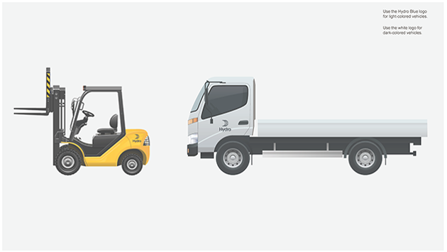 yellow forklift with small dark logo above rear wheels, lorry with logo centered on cab door. yellow forklift with small dark logo above rear wheels, lorry with logo centered on cab door.