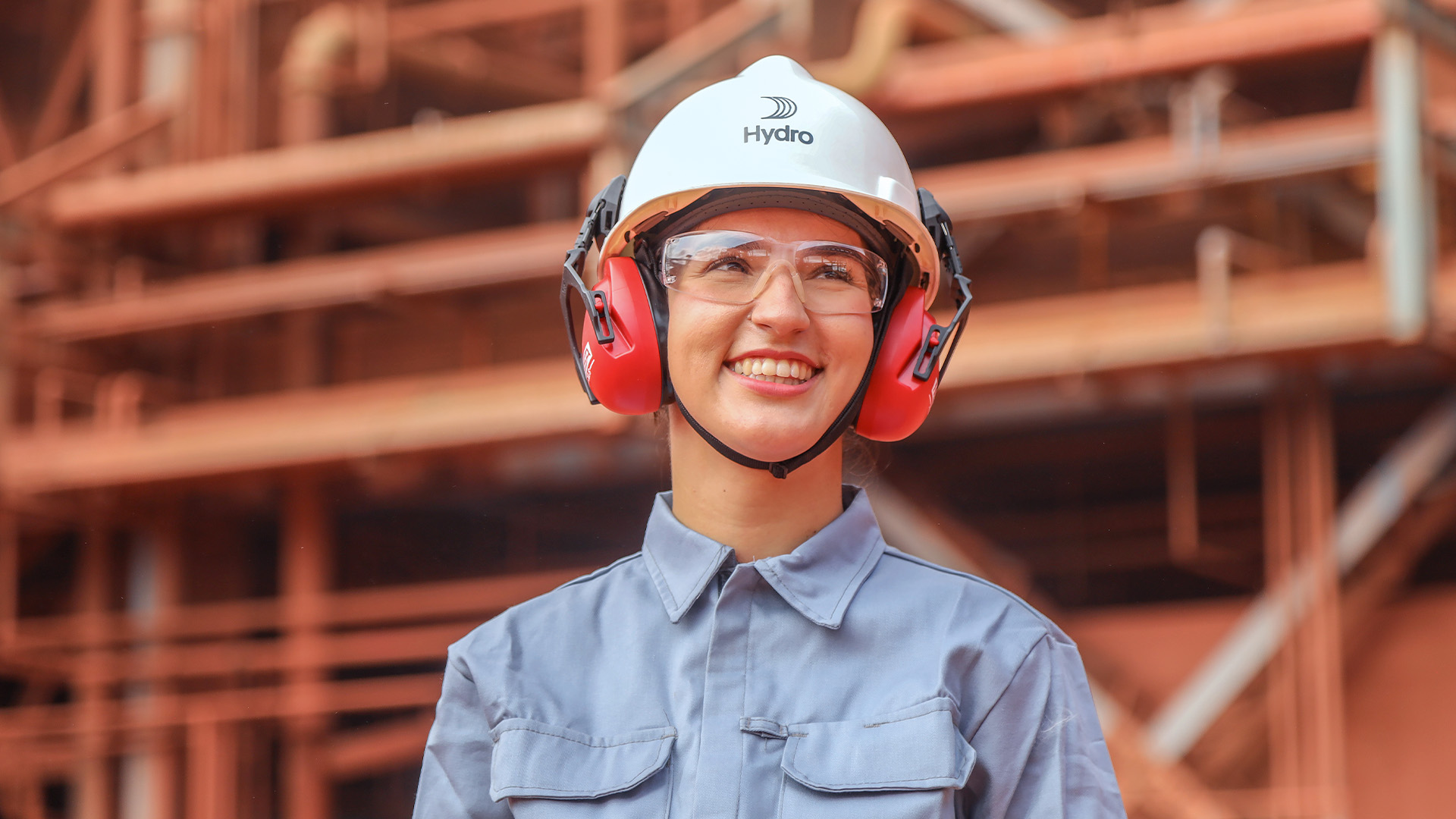 a woman wearing a hard hat and earmuffs