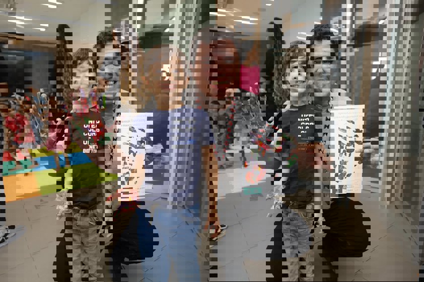 a person and a boy holding a gift box