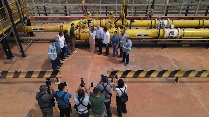 a group of people standing in front of a large machine