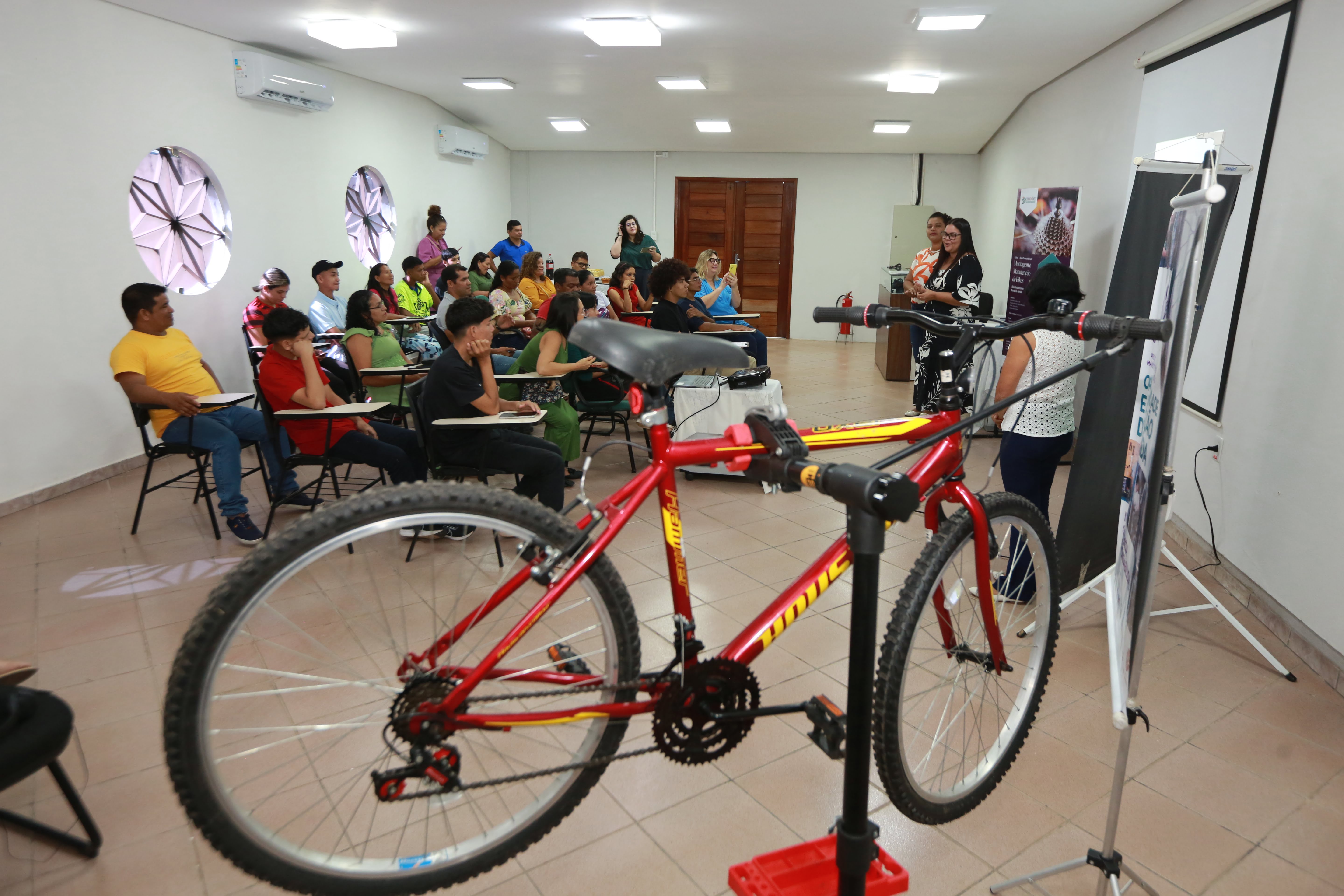 a group of people in a room with a bicycle