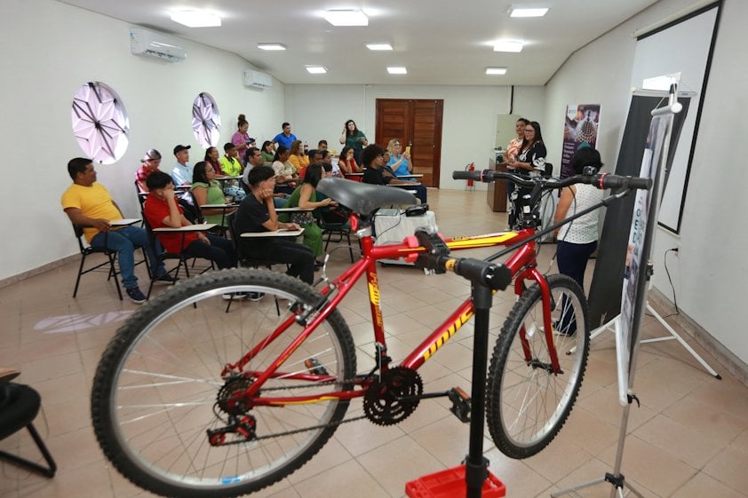 a group of people in a room with a bicycle
