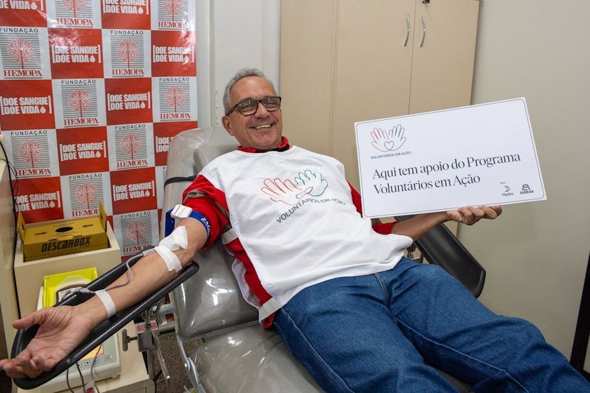 a man sitting in a chair holding a sign