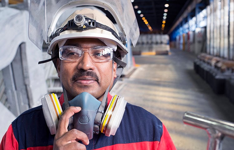 male worker in protective gear on factor floor
