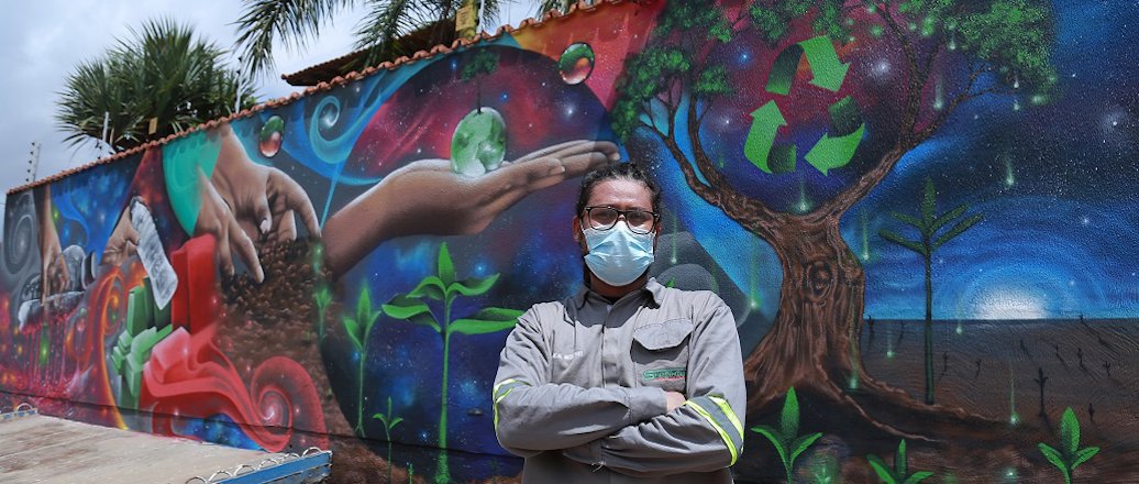 a person posing in front of a mural