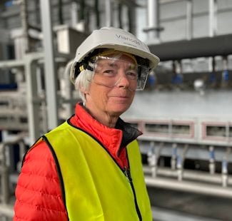 a woman wearing a hard hat and safety vest
