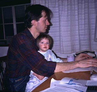 a man and a child looking at a computer