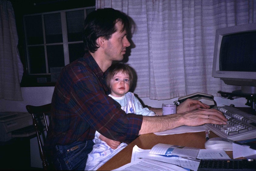 a man and a child looking at a computer