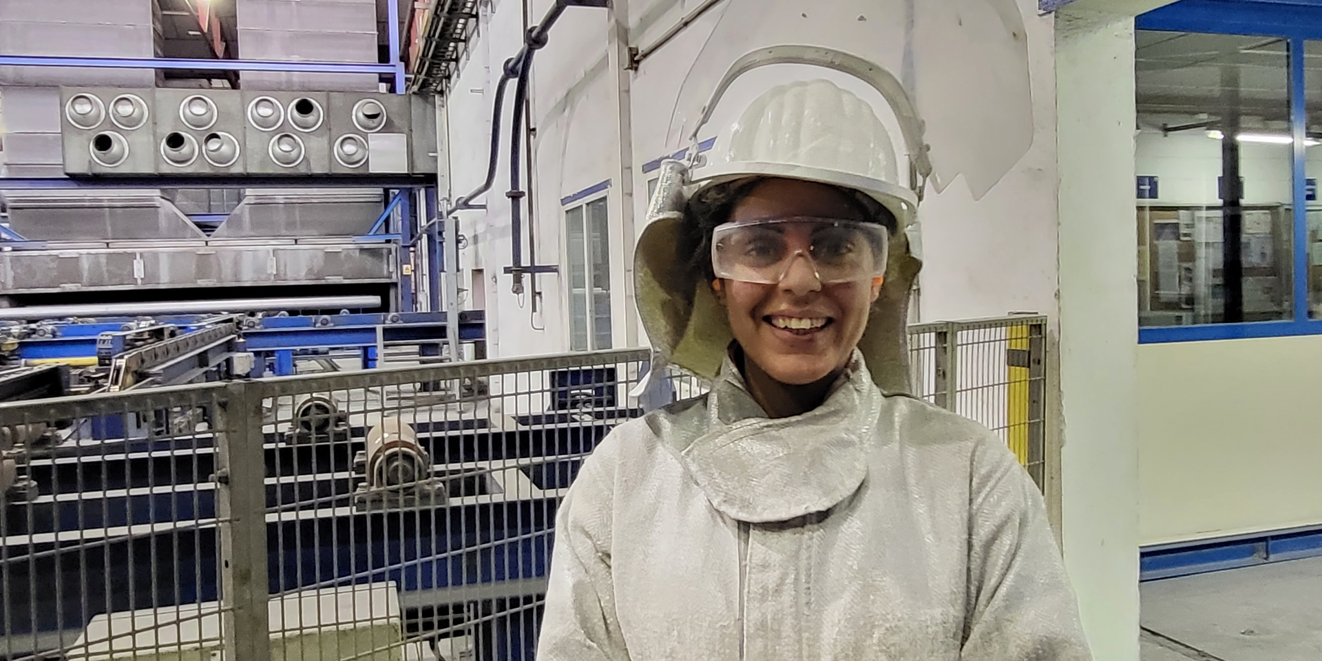 a man wearing a white coat and a hard hat