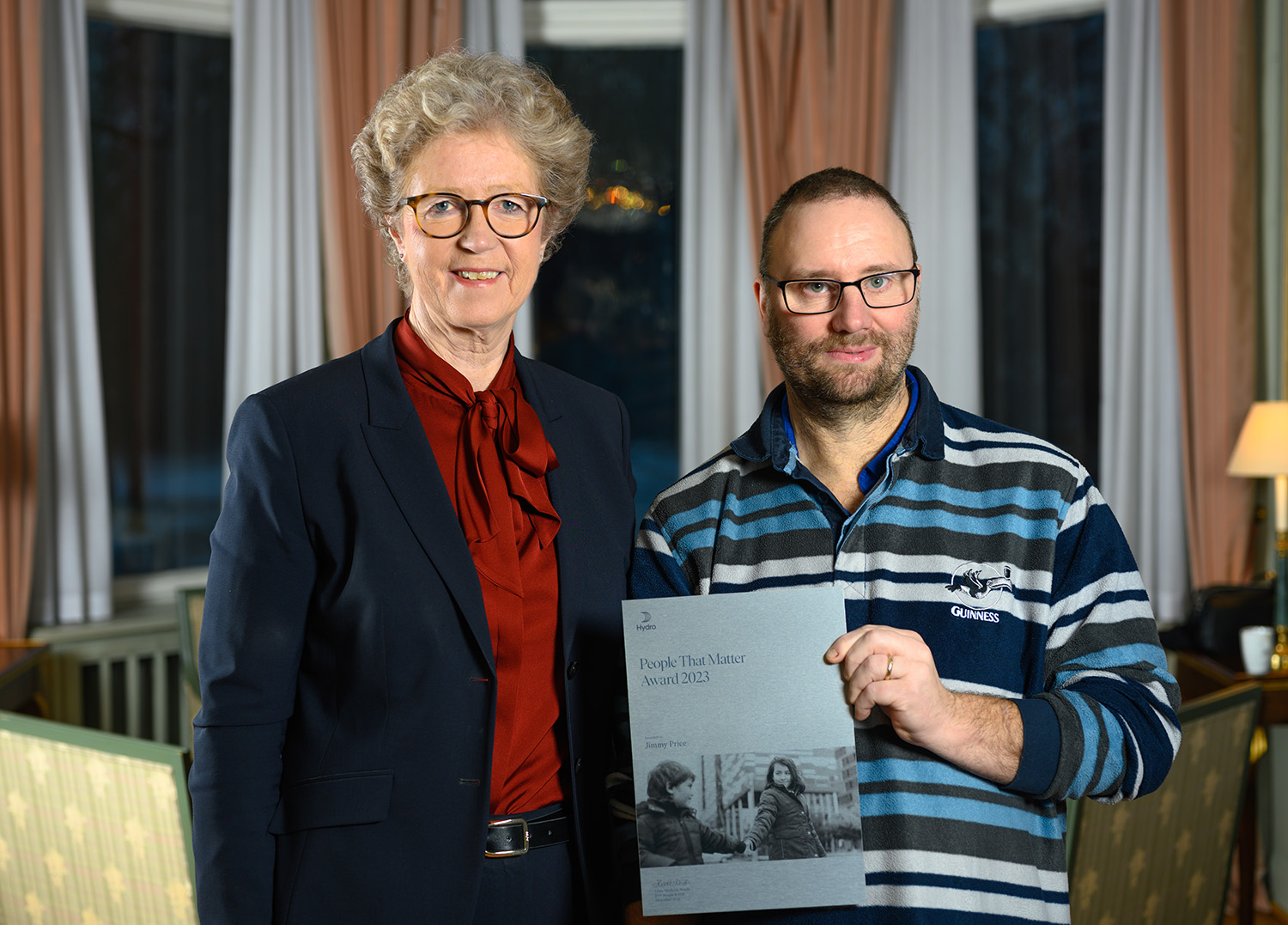 a couple of people holding an award