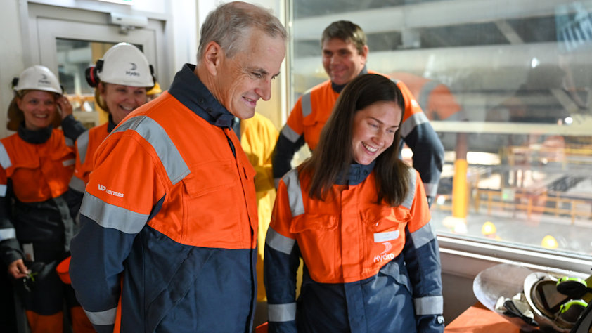 a group of people wearing orange workwear