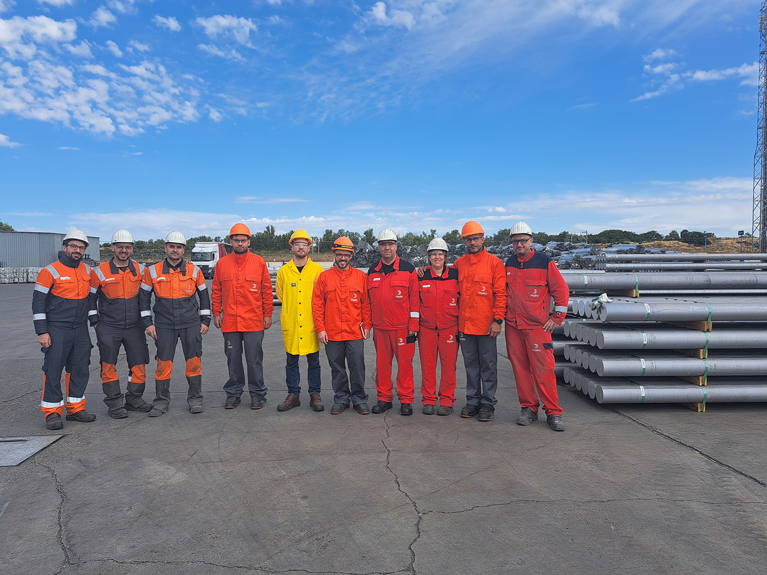 a group of people in orange jumpsuits standing on a road