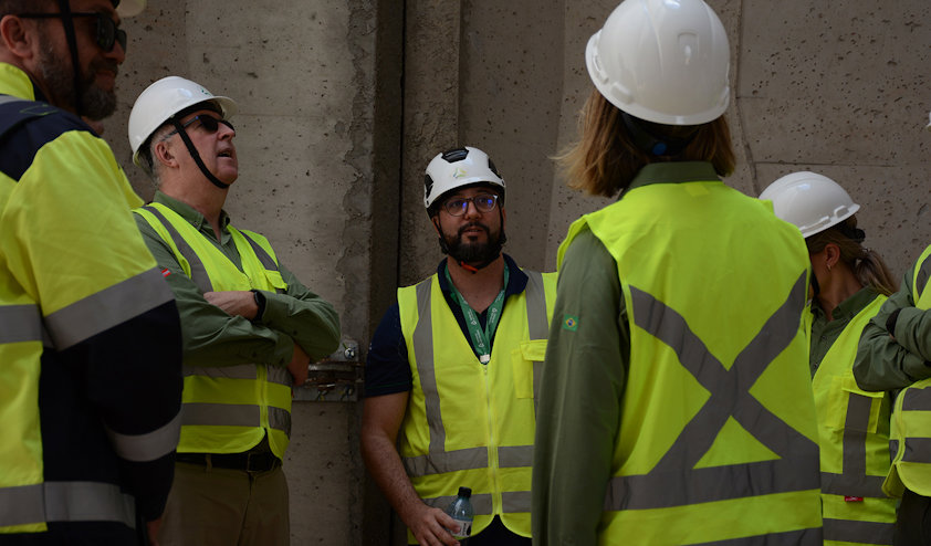 a group of people wearing hardhats and reflector vests