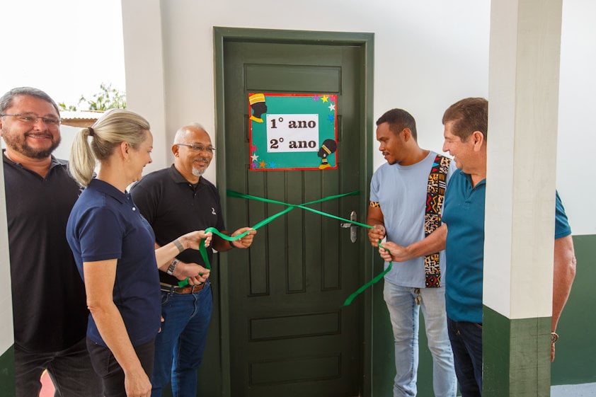 a group of men standing next to a green door