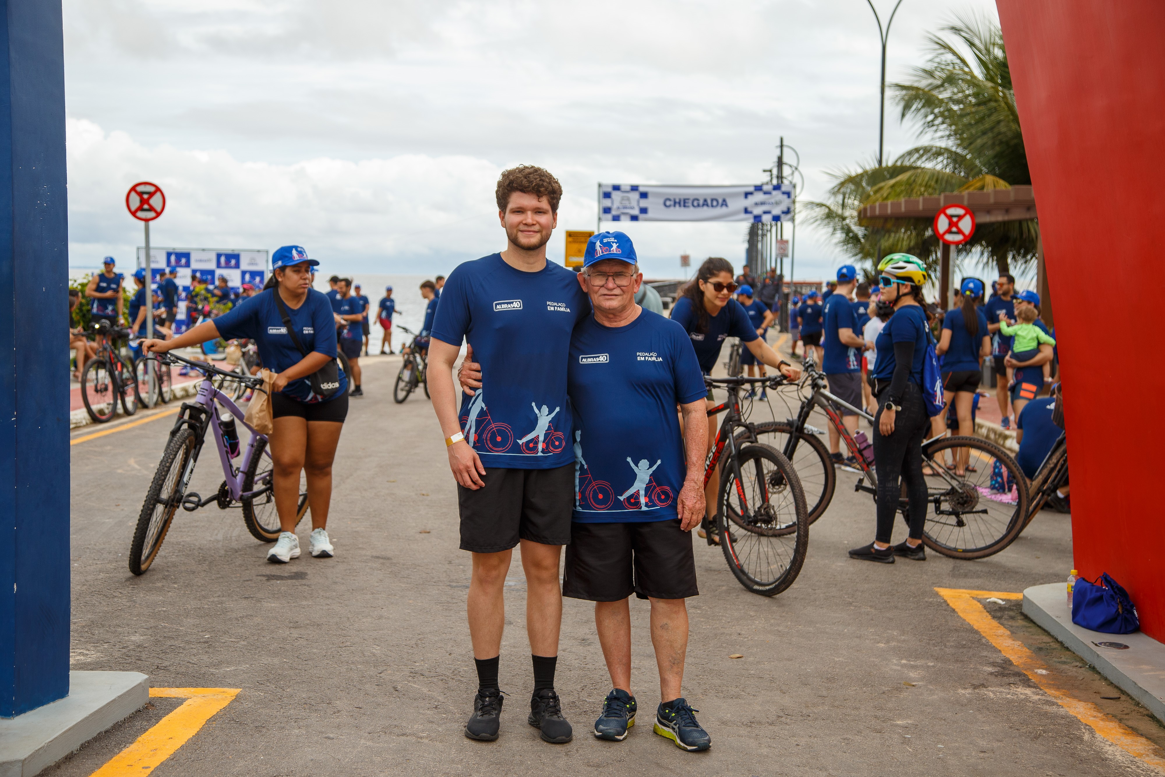 a group of men posing for a picture with bicycles in the background