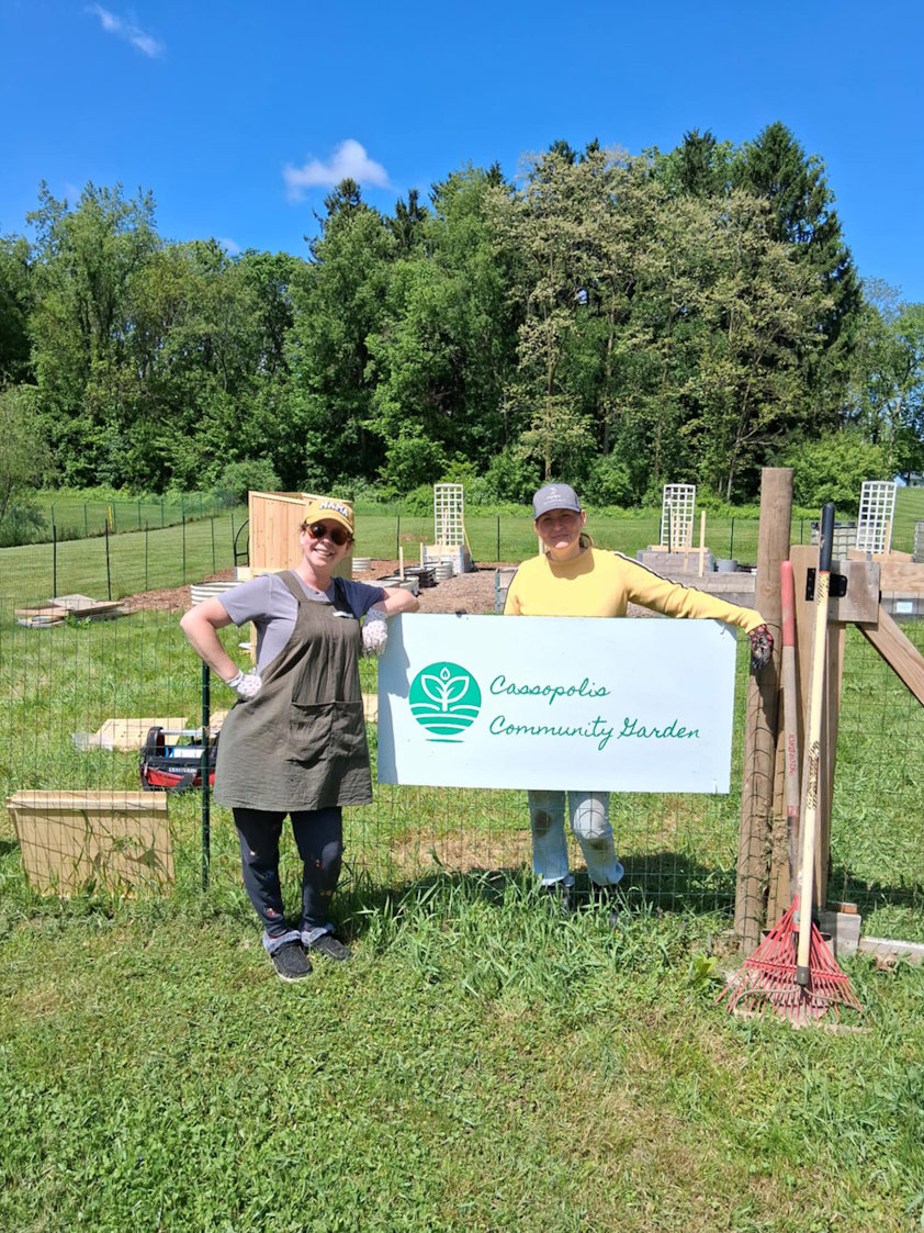 a couple of people standing near a sign