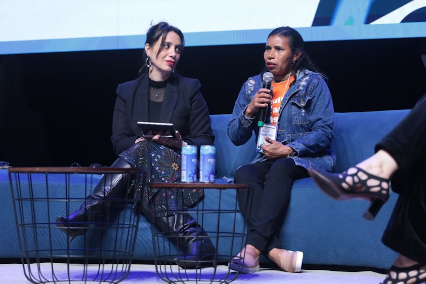 women sitting on a stage