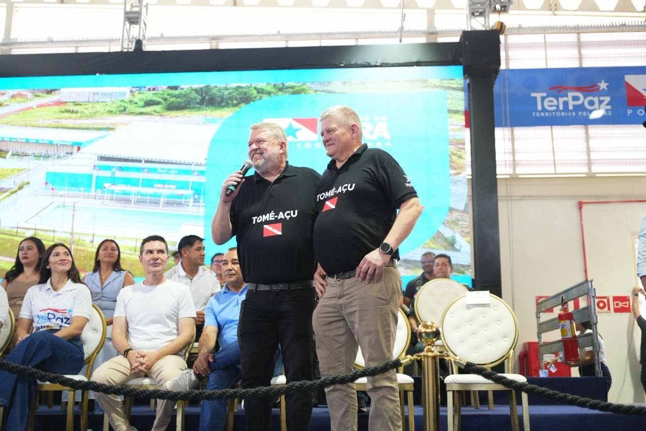 two men standing on a stage