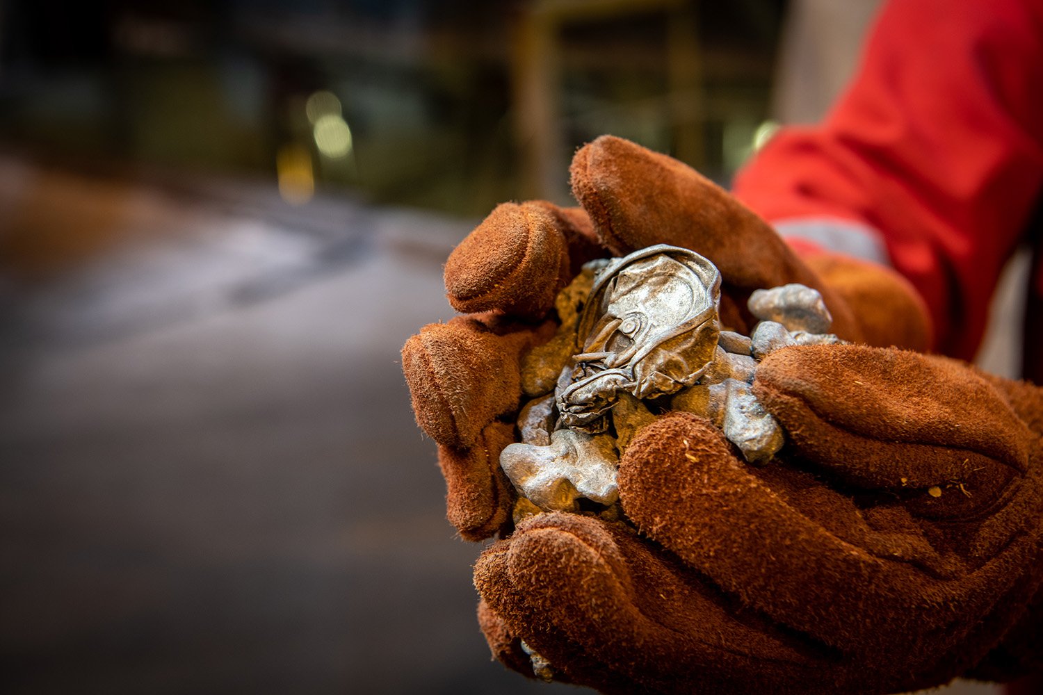 a person holding a pile of metal