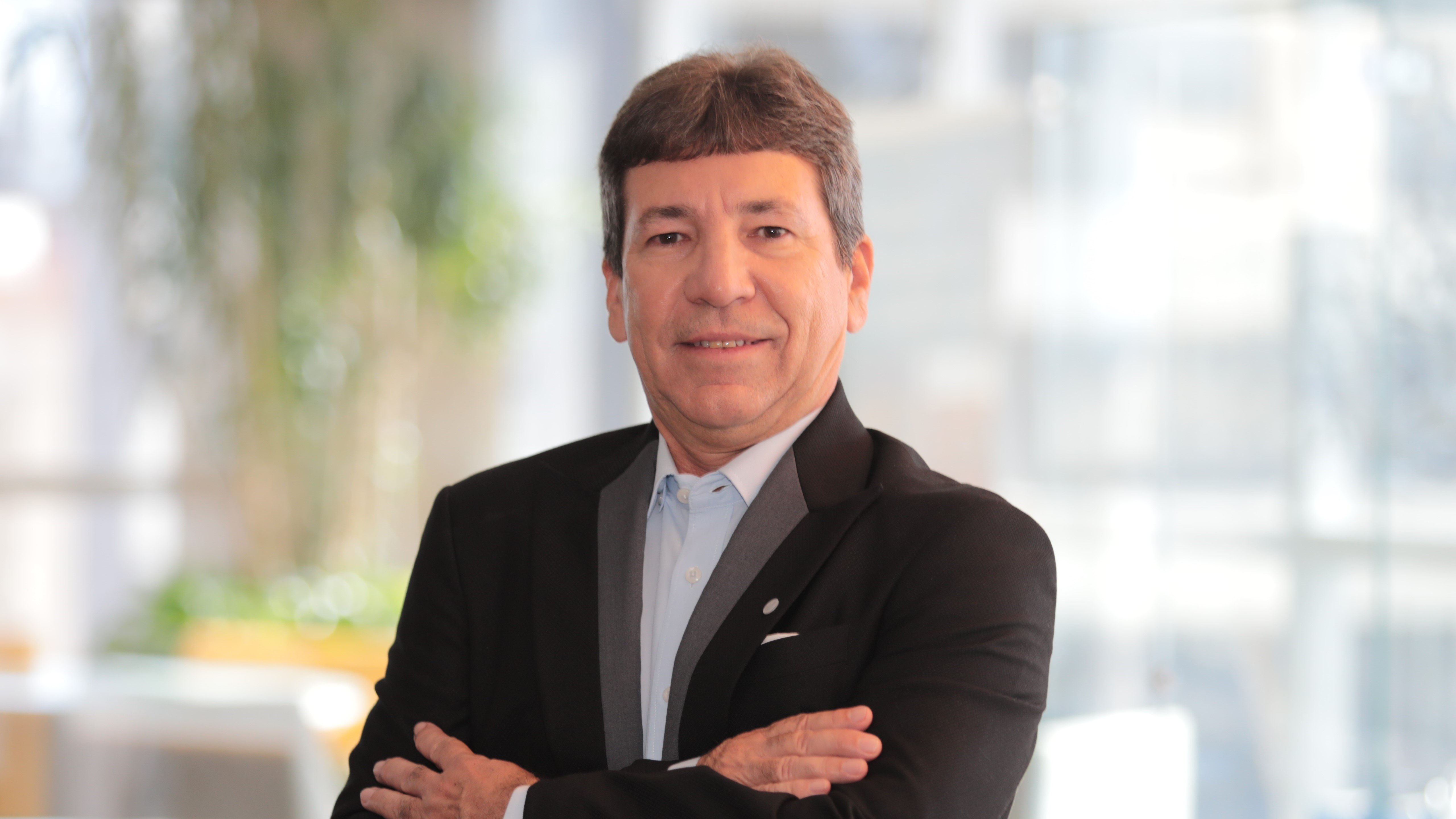a man in a suit with his arms crossed